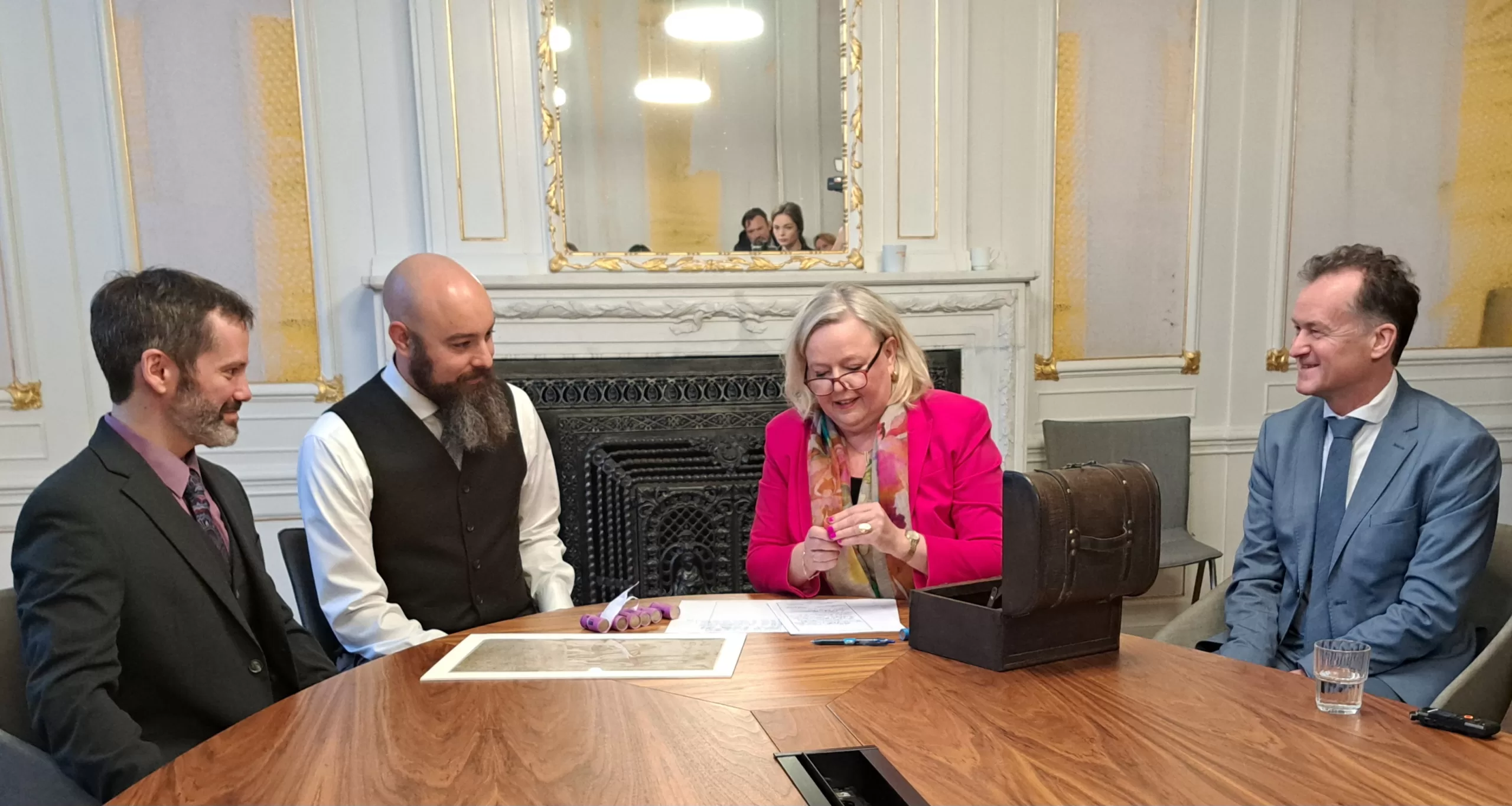 Tanja van Gurp betaalt de rente uit aan David D'Onofrio en Peter Asch van de New York Stock Exchange. Rechts dijkgraaf Jeroen Haan